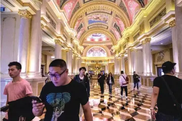  ??  ?? Visitors walk inside the Venetian casino resort in Macau. — AFP photos