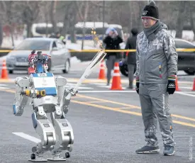  ??  ?? HUBO, a multifunct­ional walking humanoid robot, carries the Olympic torch at the Korea Advanced Institute of Science and Technology (KAIST) in Daejeon, South Korea.