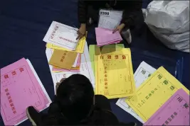  ?? LOUISE DELMOTTE — THE ASSOCIATED PRESS ?? People prepare election materials in New Taipei, Taiwan, on Friday.