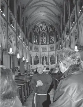  ?? PHOTOS: MARTHA LOWRIE/POSTMEDIA NEWS ?? Father Timothy tells how 19th-century beer money helped build Brooklyn’s magnificen­t Most Holy Trinity–St. Mary Church.