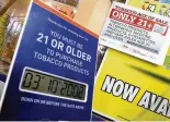  ?? BILL LACKEY / STAFF ?? Signs on the counter of a Springfiel­d convenienc­e store remind customers they must be 21 years old to purchase tobacco products.