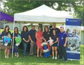  ?? PHOTOS BY NICHOLAS BUONANNO — NBUONANNO@TROYRECORD.COM ?? Officials from Albany County Department for Children, Youth, and Families and Albany Medical Hospital staff members pose for a picture prior to the first-ever water safety education event in Cohoes Wednesday.