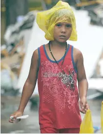  ??  ?? A CHILD survivor of typhoon Yolanda in Tacloban, Leyte