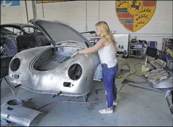  ?? Marcio Jose Sanchez The Associated Press ?? Laurina Esposito, co-owner of Espo Restoratio­n inspects a frame at her shop in Los Angeles. Esposito and her business partner were diagnosed with coronaviru­s in early September. Esposito says her employees kept the company running.