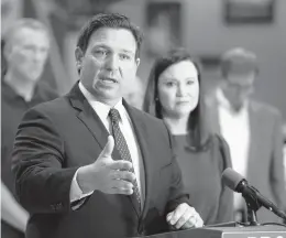 ?? CALVIN KNIGHT/THE LEDGER ?? Florida Gov. Ron DeSantis is seen with state Attorney General Ashley Moody. Florida is one of 14 states that plan to sue over President Biden’s vaccine mandate.