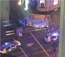  ?? KEVIN DUNNE, AP ?? Police surround the van used Saturday by three attackers to plow through pedestrian­s on London Bridge.