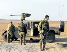  ?? MENAHEM KAHANA/GETTY IMAGES ?? Israeli soldiers patrol near the Israeli border with Gaza Strip on Monday. Several people were injured when Israel blew up a tunnel stretching from the Gaza Strip into its territory.