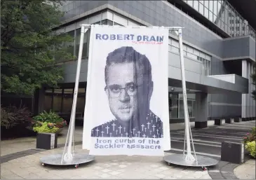  ?? Tyler Sizemore / Hearst Connecticu­t Media ?? A curtain depicting Judge Robert Drain, who is presiding over Purdue Pharma’s bankruptcy case, is displayed outside Purdue’s headquarte­rs at 201 Tresser Blvd in downtown Stamford on Wednesday.