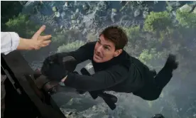  ?? ?? ‘He knows how to entertain’: Tom Cruise dangles from a crashed train in Mission: Impossible - Dead Reckoning Part One. Photograph: Paramount Pictures/Avalon