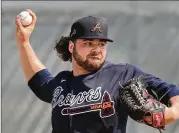  ?? PHOTOS BY CURTIS COMPTON / CCOMPTON@AJC.COM ?? Above: Bryse Wilson pitched the first two innings Sunday for the Braves against the Tigers, with four hits and two earned runs.