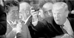  ?? BRENDAN SMIALOWSKI/AFP/GETTY IMAGES ?? President Donald Trump raises his glass to a toast by U.N. Secretary-General Antonio Guterres with Japan’s Prime Minister Shinzo Abe, left, and others at a luncheon Tuesday.