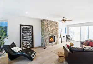  ??  ?? Alberta sandstone clads the full-height fireplace feature in the open great room that provides ample room for family and natural light with sliders to the rear deck.