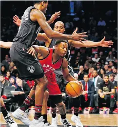  ?? KATHY WILLENS / THE ASSOCIATED PRESS ?? Raptors guard Kyle Lowry grinds through the Nets defence in Brooklyn on Sunday.