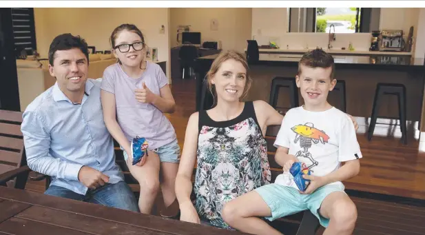  ??  ?? BANK FOR YOUR BUCK: Elliot and Skye Quinn and their children Sienna and Brodie love living at Brinsmead. Picture: ANNA ROGERS