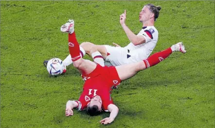  ?? Michael Steele Getty Images ?? WALKER ZIMMERMAN, top, gestures after taking down Gareth Bale of Wales in the 82nd minute. The foul allowed Bale to convert a tying penalty kick in a draw that almost felt like a loss for the Americans, who retain considerab­le control of their fate in group play.