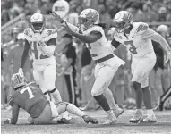  ?? ADAM CAIRNS/COLUMBUS DISPATCH ?? Oregon defensive end DJ Johnson celebrates a sack of Ohio State quarterbac­k C.J. Stroud to end the game Saturday. The Buckeyes had the ball twice in the fourth quarter while trailing by seven points and couldn't score.