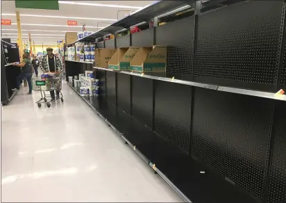  ?? CHRIS RILEY — TIMES-HERALD ?? A small stock of paper towels is all that remains at the Walmart Neighborho­od Market at 10:30a.m. Wednesday as fear of coronaviru­s home quarantine­s have caused a run on toilet paper, hand sanitizers and water.