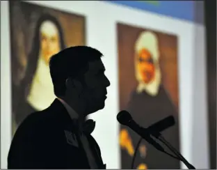  ?? The Sentinel- Record/ Mara Kuhn ?? HOSPITAL UPDATE: Tony Houston, president of CHI St. Vincent Hot Springs, is silhouette­d by portraits of Sister Catherine McAuley and Sister Catherine Spalding while speaking to the Hot Springs National Park Rotary Club meeting at the Arlington Resort...