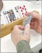  ?? (NWA Democrat-Gazette/Lynn Kutter) ?? Jay Viles looks over his cards during a game of Tic at Lincoln Senior Center. The object of the game is to be the first player each round to “tic” by getting rid of all your cards and to have the lowest number of points at the end of the game.