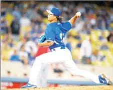  ??  ?? Los Angeles Dodgers relief pitcher Chin-hui Tsao, of Taiwan, throws to the plate during the ninth inning of an exhibition baseball game against the Los Angeles
Angels, on April 4, in Los Angeles. (AP)