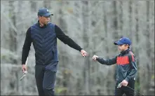  ?? AP ?? Tiger Woods enjoys a round of golf with his son Charlie at a tournament in Orlando, Florida, on Dec 17 last year.