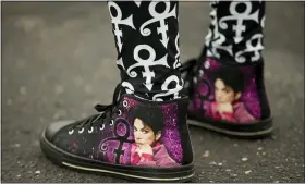  ??  ?? Lifelong Prince fan Patrice Files of Detroit wears clothing from head to toe to honor Prince on the fifth anniversar­y of his death.