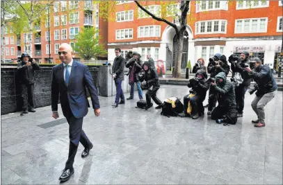  ?? Dominic Lipinski ?? The Associated Press British Home Secretary Sajid Javid walks into the Home Office in London on Monday after posing for photograph­ers. Prime Minister Theresa May named Javid home secretary on Monday.