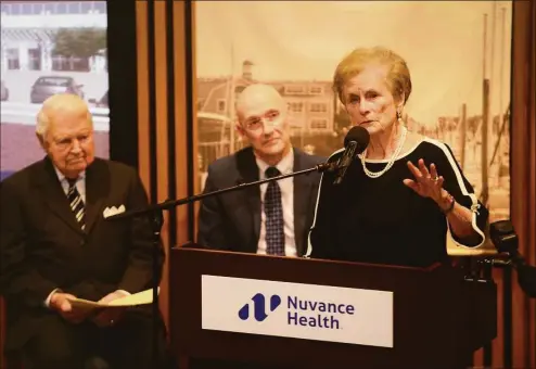  ?? Ned Gerard / Hearst Connecticu­t Media ?? Carol Bauer speaks during a ceremony at Norwalk Hospital on Wednesday as her husband, George, left, and Norwalk Hospital President Peter R. Cordeau listen. Carol and George Bauer, of New Canaan, are making a $20 million donation to the hospital.