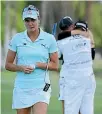  ??  ?? Lexi Thompson walks off the 18th green, as So Yeon Ryu celebrates with her caddie after Ryu beat Thompson in a playoff at the ANA Inspiratio­n tournament.
