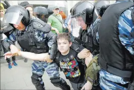  ?? Alexander Zemlianich­enko ?? The Associated Press A young demonstrat­or is apprehende­d Monday by riot police in downtown Moscow. More than 100 anti-corruption rallies were held Monday across Russia’s 11 time zones.