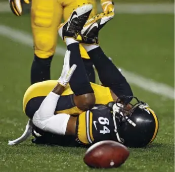  ?? KEITH SRAKOCIC/THE ASSOCIATED PRESS ?? Steelers wide receiver Antonio Brown lies injured in the end zone during the first half Sunday. Brown left the game with a left calf injury. Pittsburgh had to play most of the game without one of their top offensive weapons.