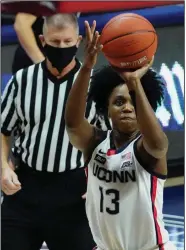  ?? (AP/David Butler II) ?? Connecticu­t guard Christyn Williams (Central Arkansas Christian) takes a shot Tuesday during the No. 3 Huskies’ 103-35 victory over the Butler Bulldogs in Storrs, Conn. Williams finished with 17 points.