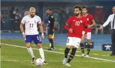  ?? (AFP) ?? Belgium’s midfielder Yannick Carrasco (left) and Egypt’s forward Mohamed Salah vie for the ball during the friendly match at Jaber Al Ahmad Stadium in Kuwait City yesterday.