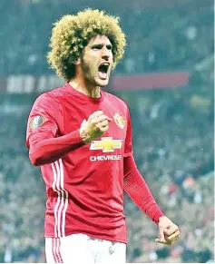 ?? — AFP photo ?? Belgian midfielder Marouane Fellaini celebrates after scoring the opening goal of the UEFA Europa League semi-final, second-leg football match between Manchester United and Celta Vigo at Old Trafford stadium in Manchester, north-west England, on May...