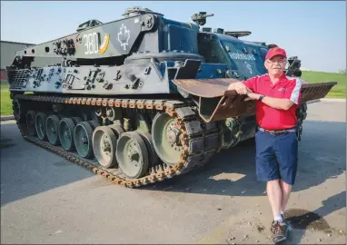  ??  ?? Retired LCol. Bill Schultz leans on the “HORNBURG” Armoured Recovery Vehicle that will be dedicated to Corporal Nathan Hornburg, who was killed in Afghanista­n in Sept. 2007, at the Military Museums in Calgary last week.