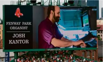  ?? BOSTON RED SOX ?? The center-field scoreboard offered a close-up view of Fenway organist Josh Kantor, who’s about to begin his 22nd season with the Sox.