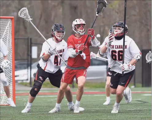  ?? Dave Stewart / Hearst Connecticu­t Media ?? Fairfield Prep’s Tyler Fox (6) battles New Canaan’s Dillon Stephens (47) and Christian Wolter for a loose ball during a boys lacrosse game on Monday at Dunning Field in New Canaan.