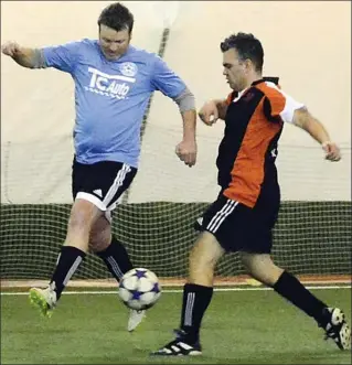  ?? VLADO ZAMECNIK/Special to the Herald ?? Mike Beliveau, left, of TC Auto, and Phil Barata of PLK battle for the ball Sunday at the Adidas Sportsplex. PLK won 10-8 to advance to the playoff final against HLW.