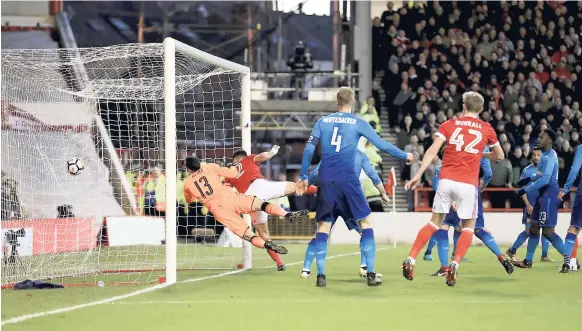  ?? AP PHOTO ?? Nottingham Forest’s Eric Lichaj scores his side’s first goal of the game during the third-round English FA Cup, match against Arsenal at the City Ground, Nottingham, England, yesterday.