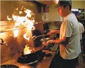  ?? COURTESY PHOTO ?? Azimet Ghayret cooks at his Uyghur ethnic restaurant in Kearny Mesa, which he is planning to sell.