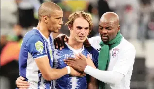  ?? PICTURE: © RYAN WILKISKY/BACKPAGEPI­X ?? Andrea Fileccia of Maritzburg United is consoled by teammate Bevan Fransman and Rooi Mahamutsa of Free State Stars after the 2018 Nedbank Cup Final between Maritzburg United and Free State Stars at Cape Town Stadium on Saturday.