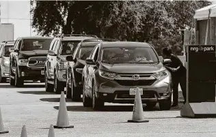  ?? Jon Shapley / Staff photograph­er ?? People drop off mail ballots at NRG Arena in Houston. Harris County planned 11 additional sites.