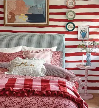  ?? ?? Lovely lines: Stripes mix well with the floral linen in this bedroom