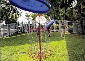  ??  ?? Wham-O employees play with new Ultimate Frisbees at the company’s headquarte­rs in Carson, Calif. CEO Todd Richards (right) said, “We always need to have fun.”