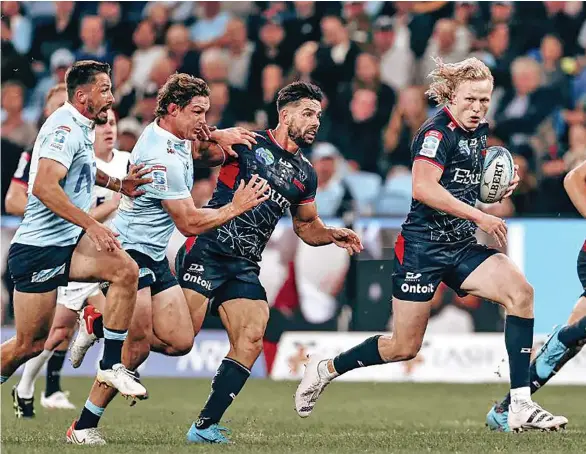  ?? Photo: Rebels Media ?? Melbourne Rebels first five eight Carter Gordon escapes the NSW Waratahs players during their Round 12 Shop N Save Super Rugby Pacific match at Allianz Stadium, Sydney on May 13, 2023.