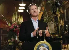  ?? AP PHOTO/RICH PEDRONCELL­I, POOL ?? Gov. Gavin Newsom discusses the reopening of businesses during a news conference at Twiggs Floral Design Gallery in Sacramento, Calif., Friday. Newsom spoke about his administra­tion’s guidance allowing retailers, including flower shops, to begin opening Friday with restrictio­ns like curbside pickup.