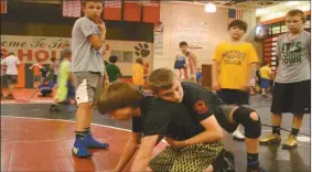  ??  ?? Wrestlers of all ages were learning the fundamenta­ls at a camp at Cedartown High School, organized by Grindhouse Wrestling of Calhoun.