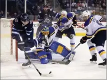  ?? TREVOR HAGAN, THE CANADIAN PRESS ?? Winnipeg’s Mark Scheifele tries to handle the puck beside St. Louis goaltender Jake Allen on Sunday, the second of back-to-back games. After losing 2-0 Saturday, the Jets bounced back for a 4-0 victory Sunday night. For complete coverage, see...