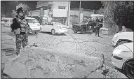  ?? AP/KARIM KADIM ?? Iraqi soldiers guard the scene after a suicide bombing Saturday in Baghdad.