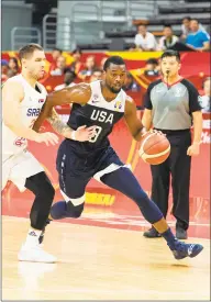  ?? Jayne Russell / AFP / Getty Images ?? The US’s Harrison Barnes drives past Serbia’s Stefan Jovic during Thursday’s World Cup game.